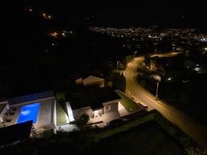a house with a blue light on the side of it at night at Villa La Lana in Mostar