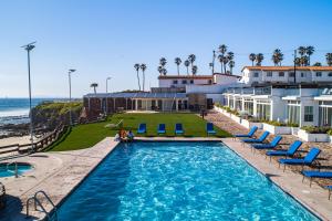 a pool with chairs and the ocean in the background at Dog-Friendly Ocean-view Villa with Patio, Outdoor Pool, Streaming, partial AC in Rosarito