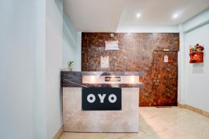 a lobby with an oo sign on a counter at Hotel O Royal Inn Hotel in Dīgha