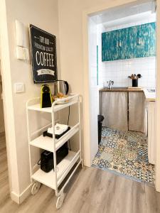 a kitchen with a white shelf and a counter at Centrico apartamento en Leganes in Leganés +5 photos