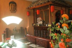 a restaurant with a table with a vase of flowers at Y Van Cac Homestay Ninh Binh Art Heritage Rice Field in Ninh Binh