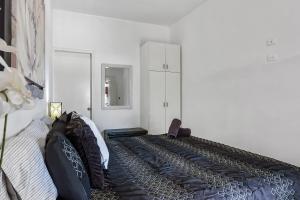 a bedroom with a bed with pillows on it at Bright Dog-Friendly Villa with Beach Views, Private Patio, Outdoor Pool, Kitchen in Rosarito +41 photos