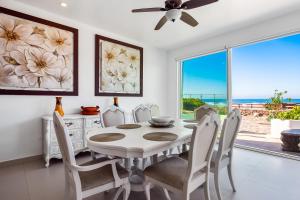a dining room with a table and chairs and a window at Airy, Beach-View Dog-Friendly Villa with Patio, Outdoor Pool, Streaming, AC in Rosarito