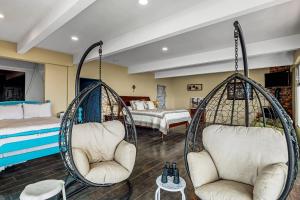 a room with two swinging chairs and a bed at Tropical Retreat with Ocean Views - Steps from the sand with alfresco dining in Rosarito