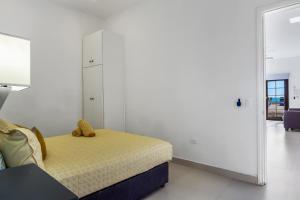 a bedroom with a bed with a teddy bear on it at Dog-Friendly Beach Haven with Heated Pool, Hot Tub, Kitchenette, Patio, AC in Rosarito +22 photos