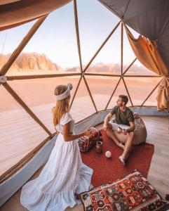 a woman and a man sitting in a tent at Ain Rum Luxury Camp in Wadi Rum +9 photos