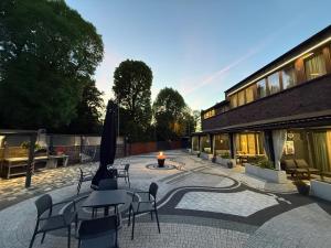 a patio with tables and chairs and a building at Desimo Home in Piła