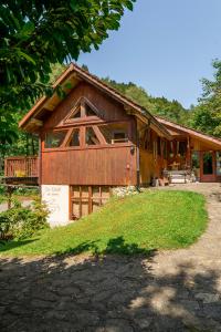 a large wooden house with a porch and a driveway at ECO-CHALET Bel Oiseau - Saint-Ursanne in Saint-Ursanne