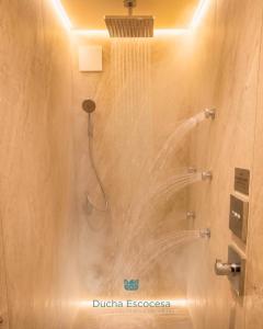 a shower with a stream of water in a bathroom at Hosteria & Spa Las Walkirias in San Martín de los Andes +51 photos