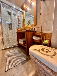 a bathroom with a shower and a bed and a sink at Jasmine Stoupa in Stoupa +38 photos
