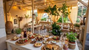 a table with many plates of food on it at Laskas Apartment in Stalís