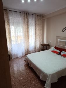 a bedroom with a large bed and a window at Aroca in Elda