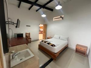 a bedroom with a bed and a sink at Hotel Cerro Bravo in Fredonia