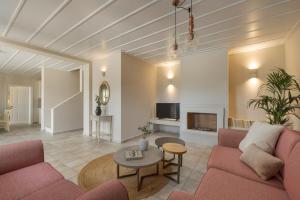 a living room with a couch and a table at Fiscardo View Villas in Fiskardo