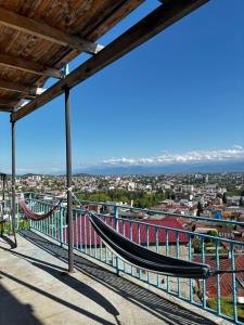 a hammock on a balcony overlooking a city at Panorama in KUTAISI in Kutaisi