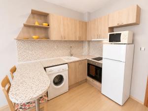 a kitchen with a white refrigerator and a washing machine at Sunny Day 3 - Pool and Chill in Sunny Beach