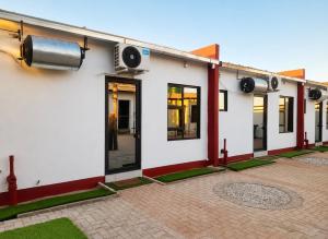 a white building with windows and a radiator at Kangumine Self Catering Units in Okakarara