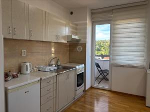 a kitchen with a sink and a stove at Apartman Pale - Biljana in Pale