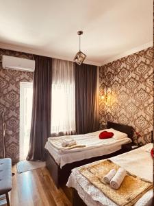 a hotel room with two beds and a window at Panorama in KUTAISI in Kutaisi