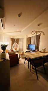 a living room with a couch and a table at Resort Living 1BR Corner Apartment with Balcony in Maribago