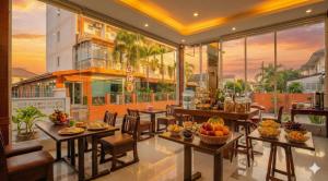 a restaurant with tables and chairs with fruit on them at เดย์ อินน์ บาย วินด์แฮม ระยอง อู่ตะเภา in Rayong