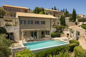 an external view of a house with a swimming pool at Fiscardo View Villas in Fiskardo