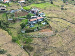 an aerial view of a house on a hill at Villa Flora Calheta Sunset & Ocean Views in Jardim do Mar