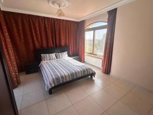 a bedroom with a bed and a window at Horizon 3 Villa in Amman