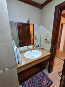 a bathroom with a sink and a mirror at Horizon 3 Villa in Amman +31 photos