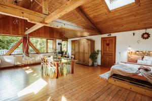 a bedroom with a bed and a table in a room at ECO-CHALET Bel Oiseau - Saint-Ursanne in Saint-Ursanne
