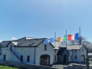 a building with three flags on top of it at Breesy Centre Apartment in Donegal