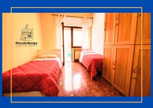 a bedroom with two beds and a dresser at Piccolo Borgo Affittacamere BIKE FRIENDLY in Taranto