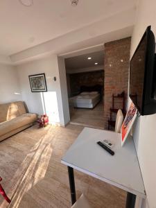 a living room with a couch and a table at Lotus 4 Mevsim Otel in Ayvalık