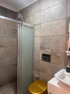 a bathroom with a shower with a toilet and a sink at Lotus 4 Mevsim Otel in Ayvalık