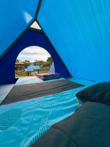 a blue tent with a bed in it at Camping El Paraiso in Calima