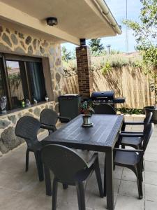a black table and chairs on a patio at montepino 2 in Maello