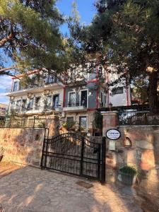 a house with a gate in front of it at Lotus 4 Mevsim Otel in Ayvalık