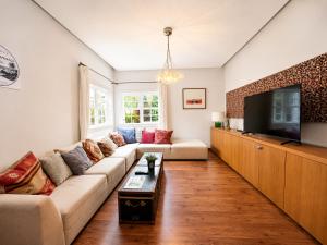 a living room with a couch and a flat screen tv at Deluxe Coliving Islas Canarias in Las Palmas de Gran Canaria +95 photos