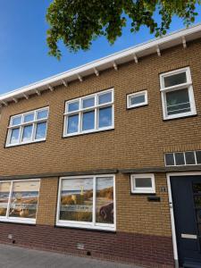 a brick building with windows on the side of it at Zeeuws Ontspannen - Privé Wellness & Suites in Middelburg