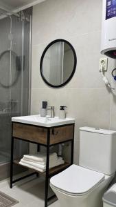 a bathroom with a sink and a toilet and a mirror at Кристалл in Bosteri