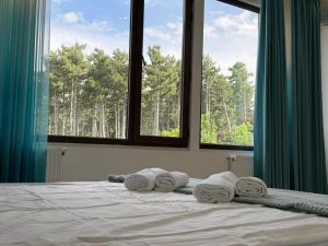 a bedroom with a bed with towels on it at Kaya Telavi in Telavi