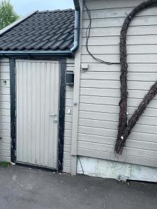 a building with a garage with a door at Modern basement apartment, 65 square meters in Alta