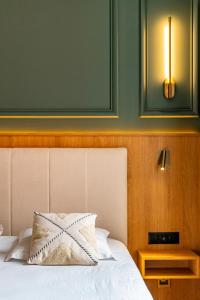a bedroom with a bed with a pillow on it at Hotel Relais De La Cote D'or in Semur-en-Auxois