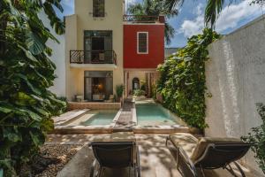 a house with a swimming pool in a yard at Casa Zafiro Hotel - Adults Only, Mérida in Mérida