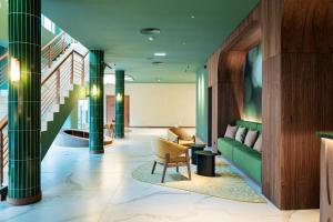a lobby with green columns and a green couch at Sao Miguel Park Hotel in Ponta Delgada
