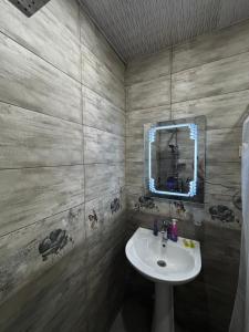 a bathroom with a sink and a mirror at Panorama in KUTAISI in Kutaisi