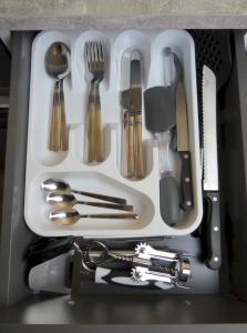 a white tray with utensils in a drawer at Rainbow View in Ellesmere
