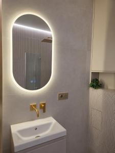 a bathroom with a sink and a mirror at Apartament Premium Orzysz in Orzysz +20 photos