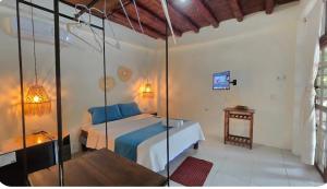 a bedroom with a bed with blue pillows at Hotel Sumpa in Montañita