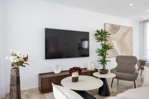 a living room with a couch and a tv at Fely Sea Villa in Novo Sancti Petri